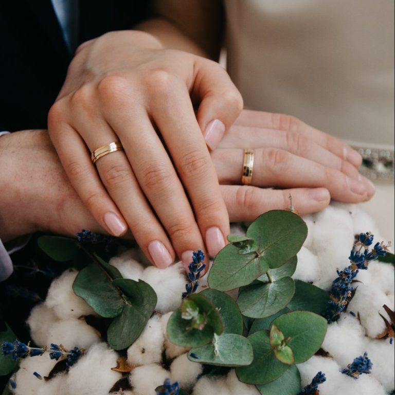 hands of couple with wedding rings